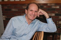 Photograph of the author Tony Renzoni sitting in a chair.